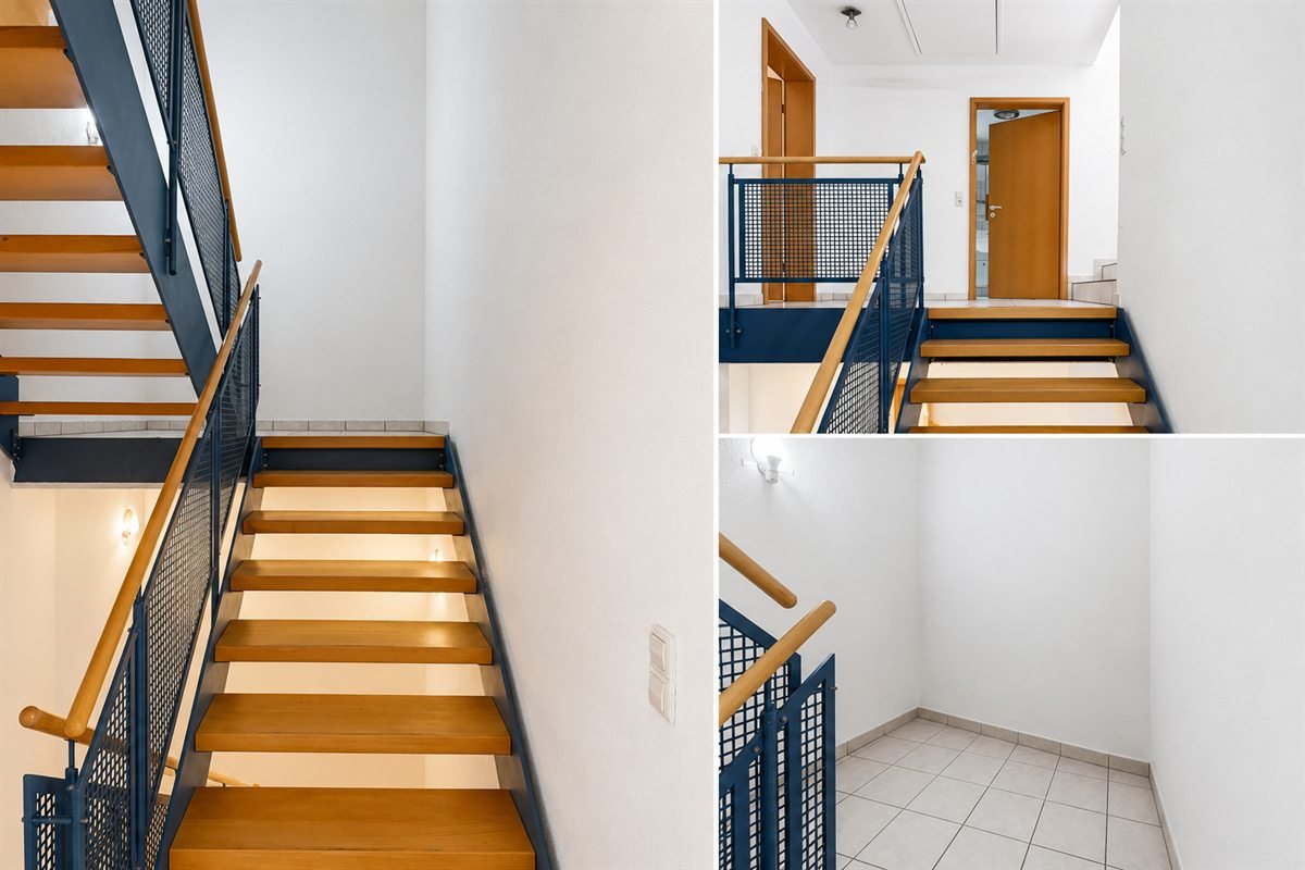 Gereinigtes Treppenhaus mit Holzstufen und blauem Metallgeländer in einem Freiburger Objekt
